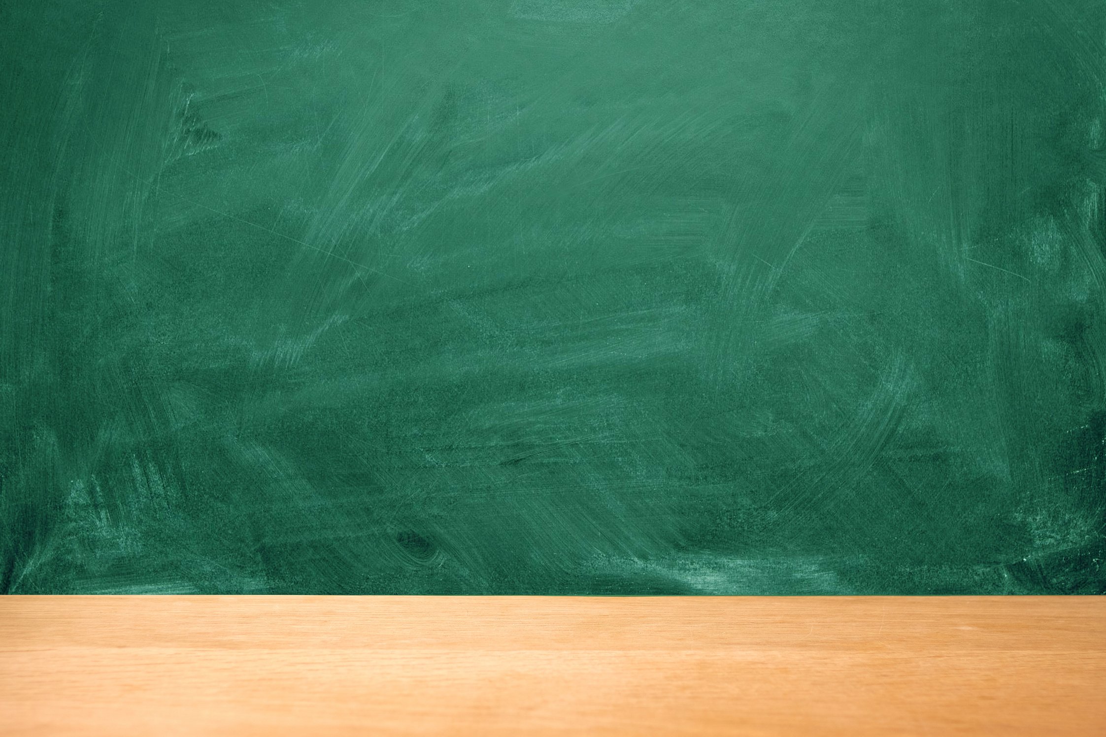 Green chalk board with chalk stains, selective focus, copy space